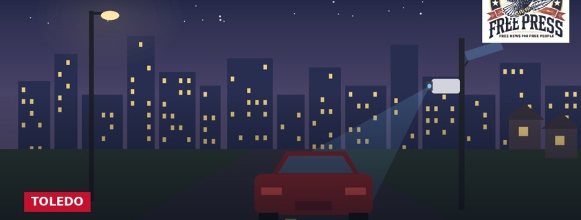Fostoria News Night cityscape with a red car and city lights for Fostoria Free Press.